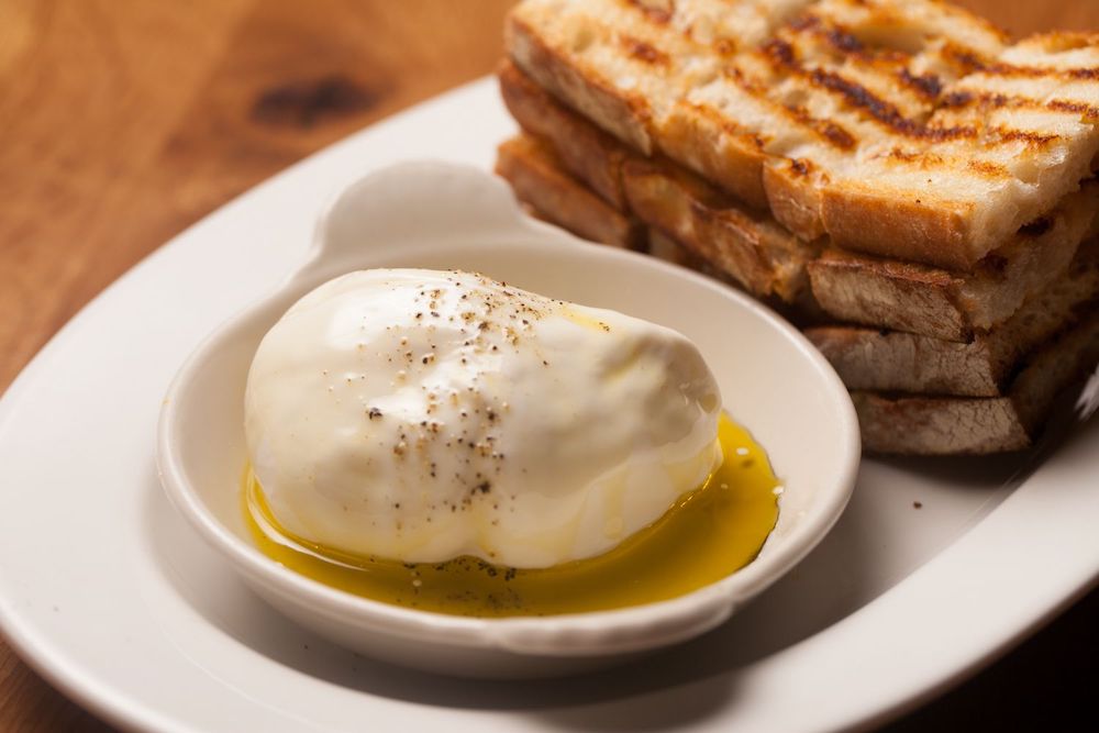 Stefano Burrata Cheese with cracked black pepper and extra virgin olive oil served with toasted Ciabatta bread at Osteria Via Stato.