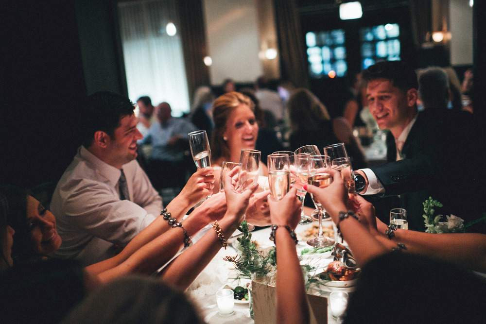 Wedding table toasting with champagne glasses