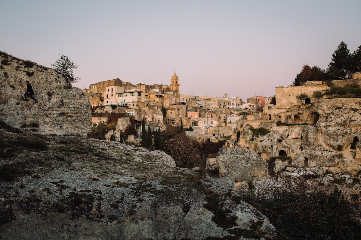 Homes built into a rocky hillside in Puglia, Italy.