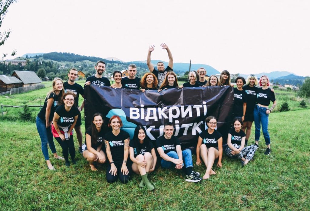 Photo of the team with the banner depicting organisation's logo.