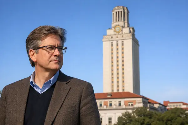 A distinguished middle-aged male architecture professor with glasses, standing thoughtfully in fr...