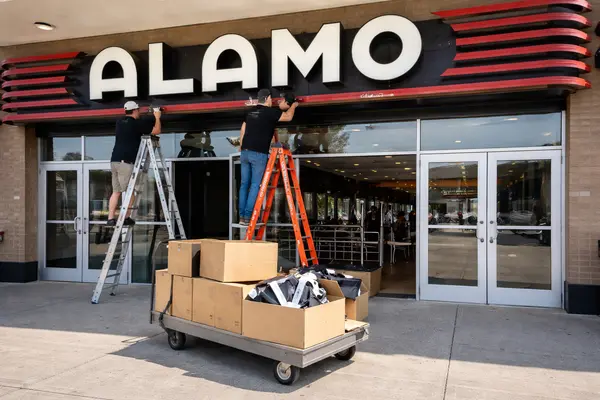 Daytime photo of the exterior entrance of the former Alamo Drafthouse LaCenterra in Katy: workers...