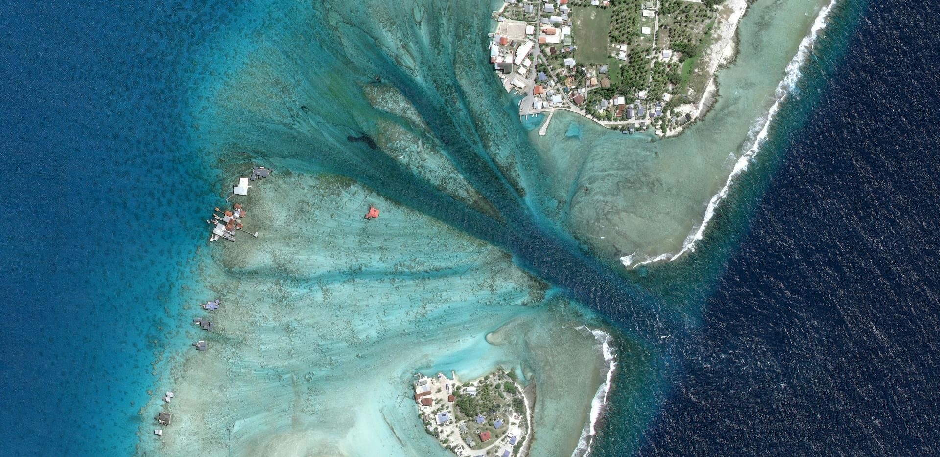 Banner image satellite view of two islands with a colour contrast in the ocean because