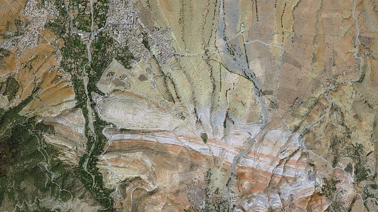 Banner satellite view of a large field illustrating climate disaster