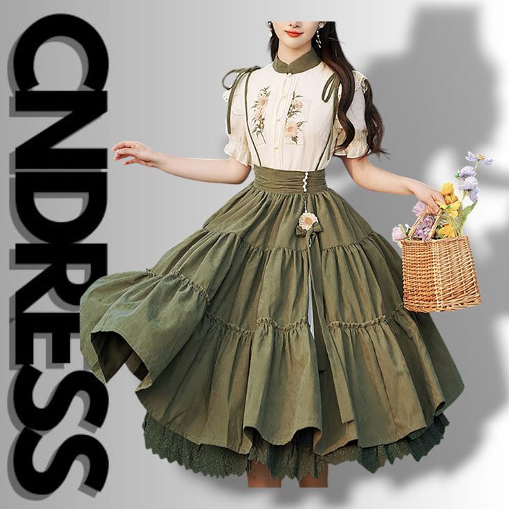 a woman is captured in a studio setting, modeling an olive green vintagestyle dress. the dress features a floral embroidered bodice, a high waist, and a flowing, tiered skirt with a lace underskirt. the model is holding a wicker basket filled with colorful flowers.