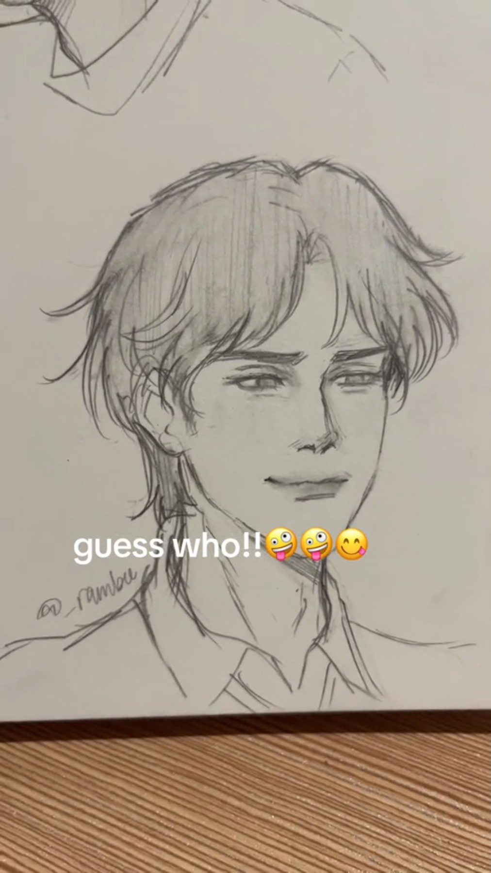 a pencil drawing of a man with a smile. he looks happy and cute, his eyes are wide open and his hair is styled in a way that makes him look youthful. the drawing is labeled "guess who!!" indicating that the viewer is expected to identify the person drawn. the drawing is done in a cartoonish style, with exaggerated features and a simple background.