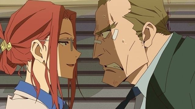 the image is a close up of a man and a woman in a tense moment. they are both anime characters, and the man has an angry expression while the woman appears to be more reserved. the man is wearing a suit and tie, while the woman is dressed in a more casual outfit. the background is a blurry image of a building or office.