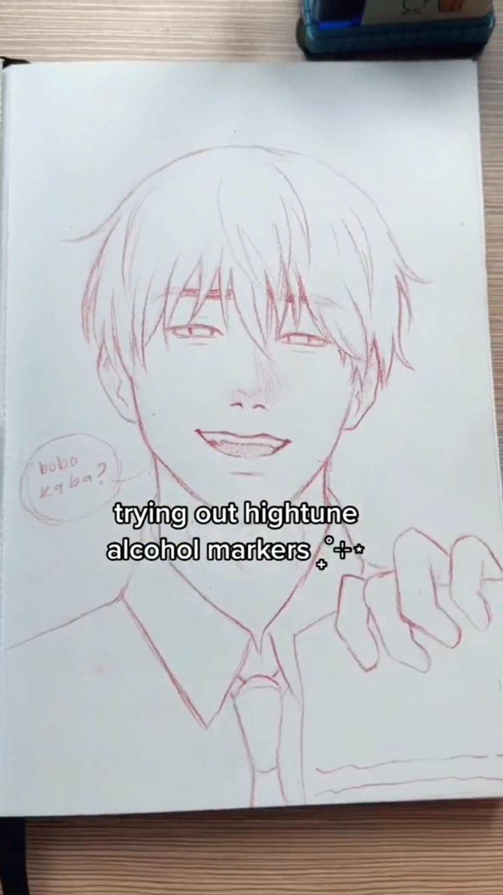 a closeup image of a drawing of an anime boy's face on a white paper. the drawing is done in red pencil and is almost complete. the boy has short, spiky hair, brown eyes, a small nose, and a wide, charming smile. he is wearing a white shirt with a red collar and tie. the word "hobo" is written in the bottom left corner. in the bottom center of the image, the text "trying out hightune alcohol markers" is written in black font.