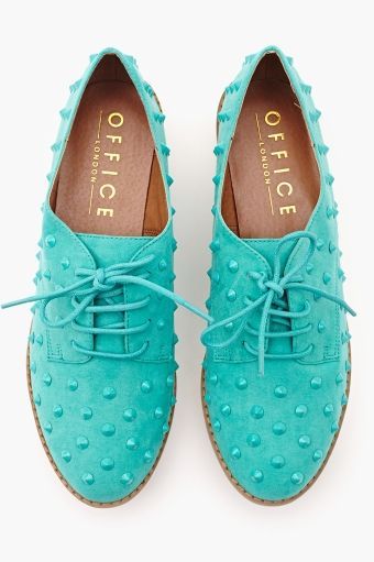 a pair of aqua blue suede office london shoes with a laceup design and studded detailing are photographed against a white background. the shoes are low top, making them comfortable and stylish for any occasion.