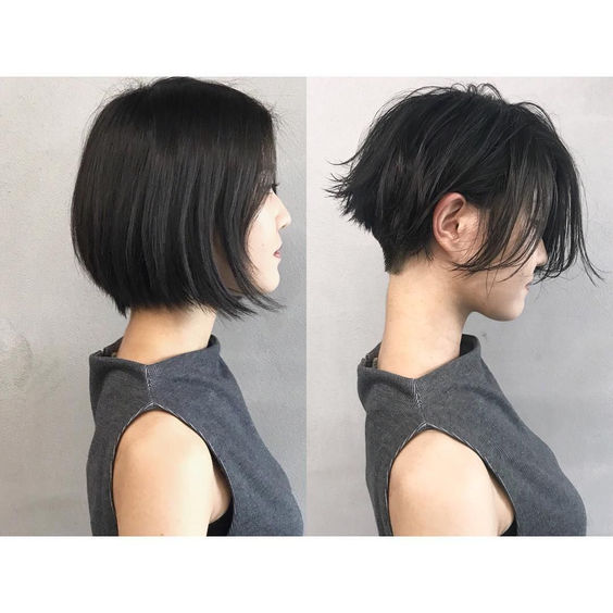 the image shows a beforeandafter comparison of a woman's haircut. the "before" photo on the left shows her with a sleek, chinlength bob. the "after" photo on the right shows her with a much shorter, choppy pixie cut with longer pieces framing her face. she is wearing a simple, gray sleeveless top in both photos, and the background is a plain white wall. the lighting is bright and even, highlighting the dramatic change in her hairstyle.