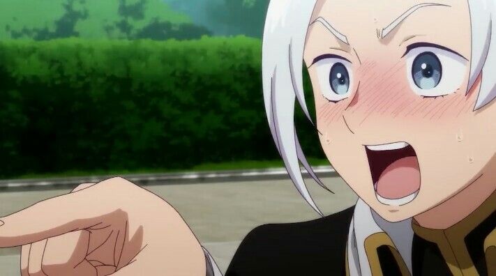 a closeup of an anime girl with white hair. her mouth is wide open in shock, and her cheeks are flushed red. she is pointing with her finger. the background is a blurred out image of a green hedge.