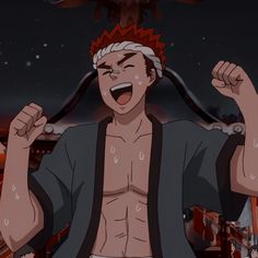 this is a closeup screenshot of an anime character, presumably male. he is shown from the chest up, facing forward with both arms raised in celebration. he is smiling widely and appears happy. he has red spiky hair with a white headband, tan skin, and is wearing a dark grey robelike garment that's partially open, revealing his chest. the background suggests an indoor setting, possibly with traditional japanese architecture, lit with a bright, possibly celebratory, light. the overall color palette is warm and dark.