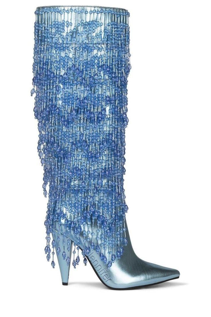 a blue, kneehigh boot with a pointed toe is covered in blue beads that form a fringe design.