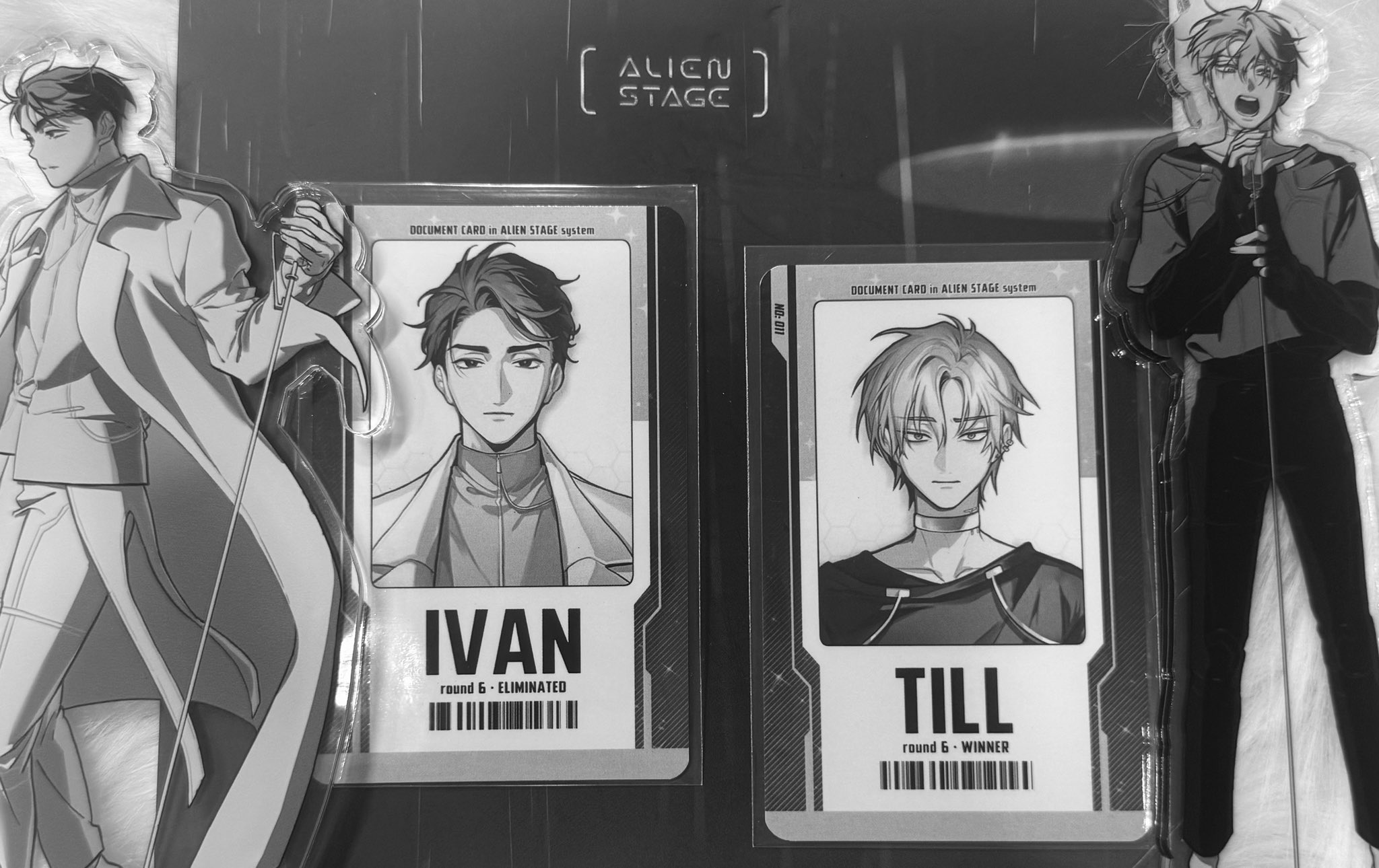 the image is a black and white photo of two document cards from a game called 'alien stage'. the card on the left shows the character 'ivan' who was eliminated in round 6. the card on the right shows the character 'till' who is the round 6 winner.
