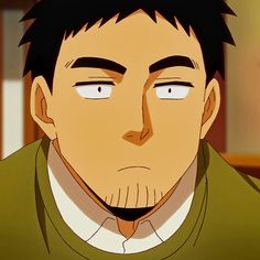 a portrait of an adult man with short black hair and stubble. he has a serious expression on his face and is looking directly at the viewer. the lighting is soft and the overall tone of the image is warm. he appears to be wearing a green sweater over a white shirt.