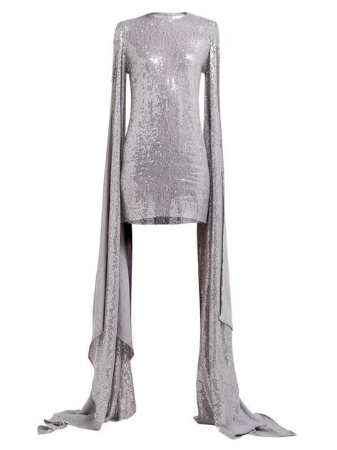 a silver sequined mini dress with long, dramatic cape sleeves. the dress has a round neckline and a fitted silhouette. the sleeves are very long and flowy, creating a dramatic effect.