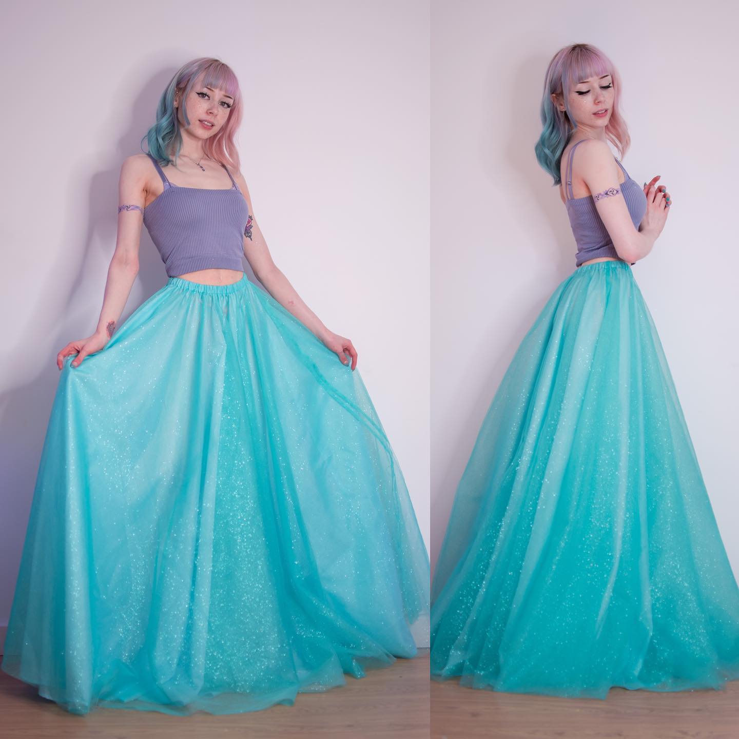 the image shows a young woman with pastel pink and blue hair wearing a light teal tulle maxi skirt with glitter.  the skirt is full and flowing.  she also wears a gray cropped top. the photo is split into two showing the woman from the front and side. the background is plain white, drawing attention to her outfit and styling. the overall aesthetic is pastel goth or whimsical.