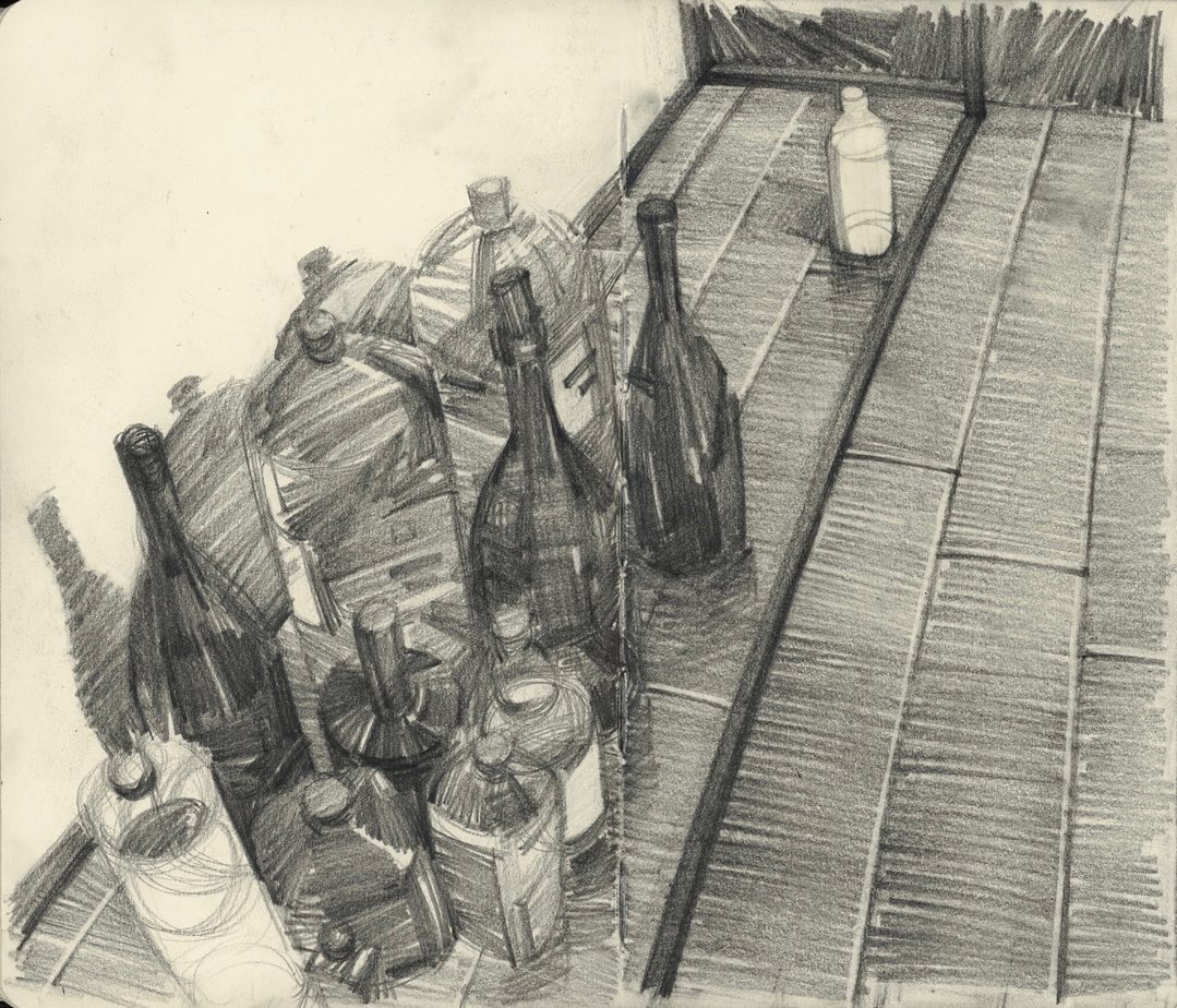 this is a black and white charcoal drawing (or sketch) of various bottles grouped together on a table. the bottles are all glass and appear to be empty. they vary in size and shape, some with labels still intact. the table is simple, with lines suggesting a tiled surface. the artwork utilizes a range of values to depict the form and texture of the bottles and the play of light and shadow.