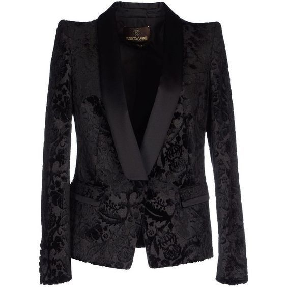 the image shows a black, velvet blazer with a floral pattern. the blazer has a tailored fit and features a contrasting satin lapel, adding a touch of formality. it appears to be a designer piece, possibly from roberto cavalli, based on the label visible in the neckline. the blazer is ideal as formal wear.