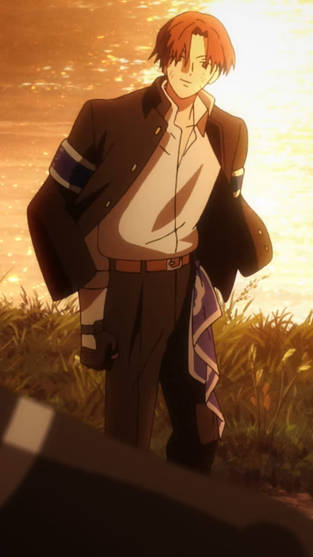 he image features an anime male with short red hair, standing confidently in a field at sunset. he's wearing a dark school uniform with a white shirt, accented by a blue armband and sash. the setting sun casts a warm glow around him, highlighting his silhouette.
