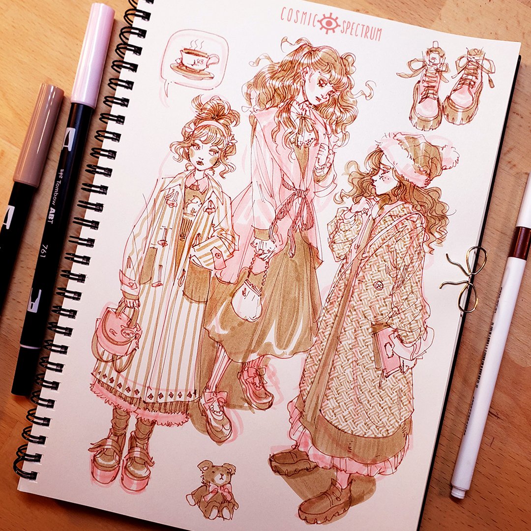 the image shows a sketchbook page filled with charming fashion illustrations. three girls, drawn in a soft, mangainspired style, are depicted wearing various winter coats and boots. the artwork is primarily in sepia tones, created using copic markers, giving it a vintage and aesthetic feel.  smaller details include a coffee cup, a teddy bear, and a pair of boots, adding to the overall whimsical mood. the sketchbook itself is visible, showing its spiral binding and the copic markers used to create the drawings.  the overall style is cute and elegant, suggesting a focus on fashion design or character design.