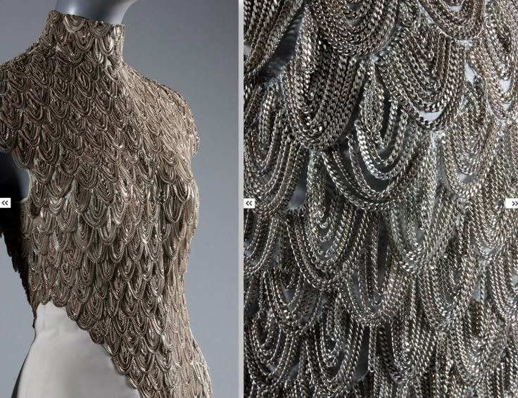 the image shows a closeup of a dress or top constructed from metal chainmail. the chains are arranged in a scalelike pattern, creating a textured and layered effect. the garment is displayed on a mannequin, showcasing the intricate design and craftsmanship. a detailed closeup on the right emphasizes the texture of the chains.