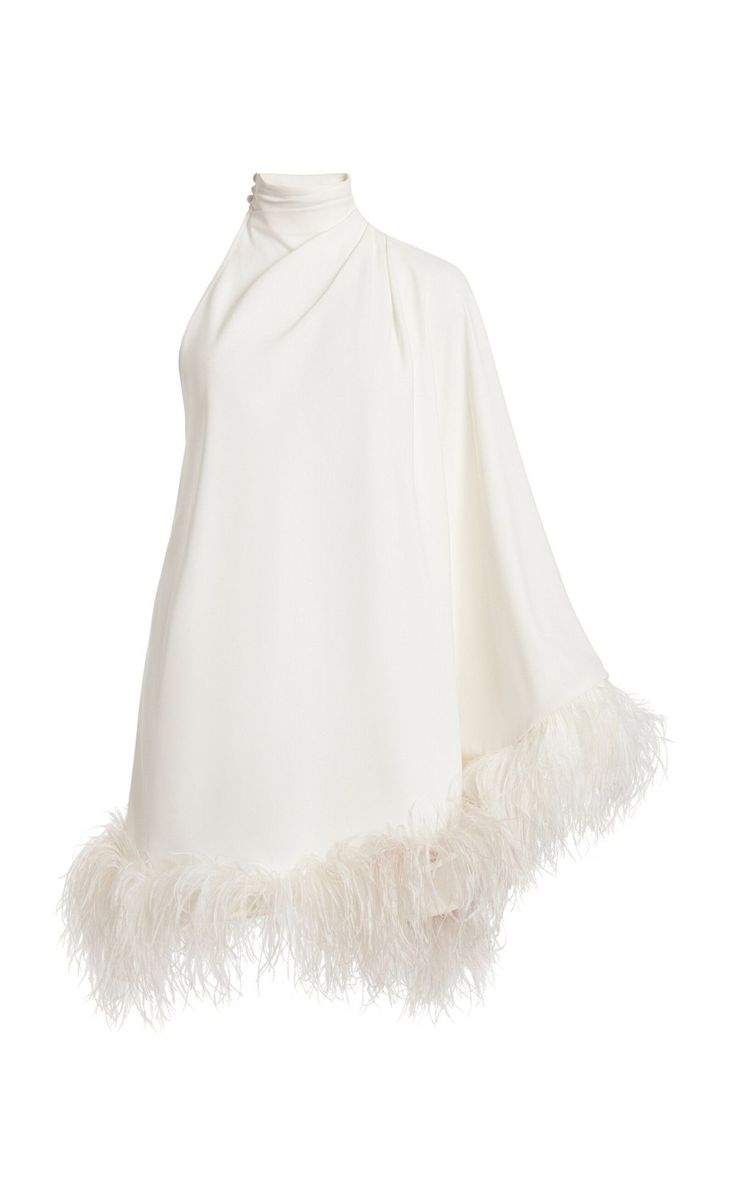 a white, oneshoulder dress with a high neck and feather trim on the hem is shown on a white background.