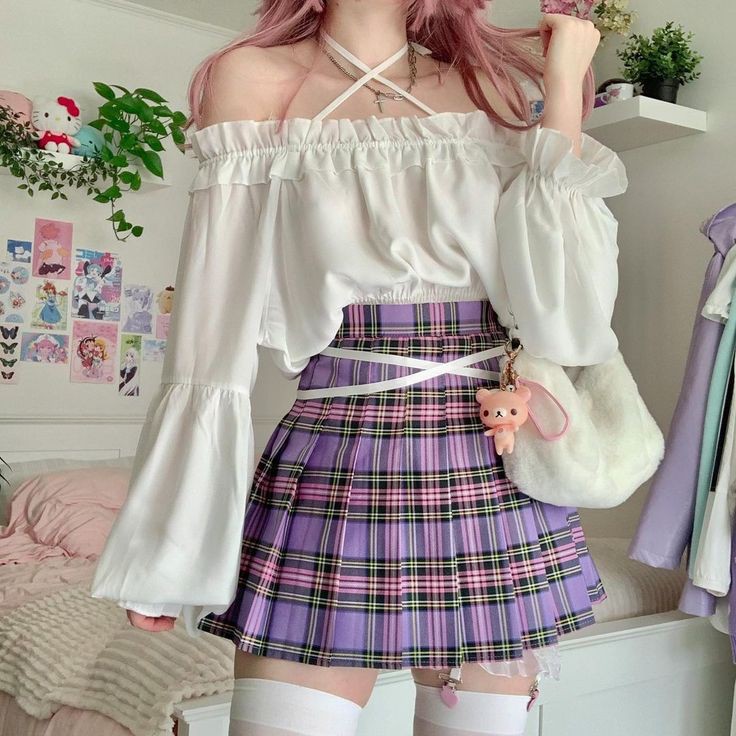 a woman with pink hair is wearing a white offshoulder blouse and a purple plaid skirt. she has white thighhigh socks on, and a teddy bear keychain hangs from her skirt. the background is a pastel bedroom.