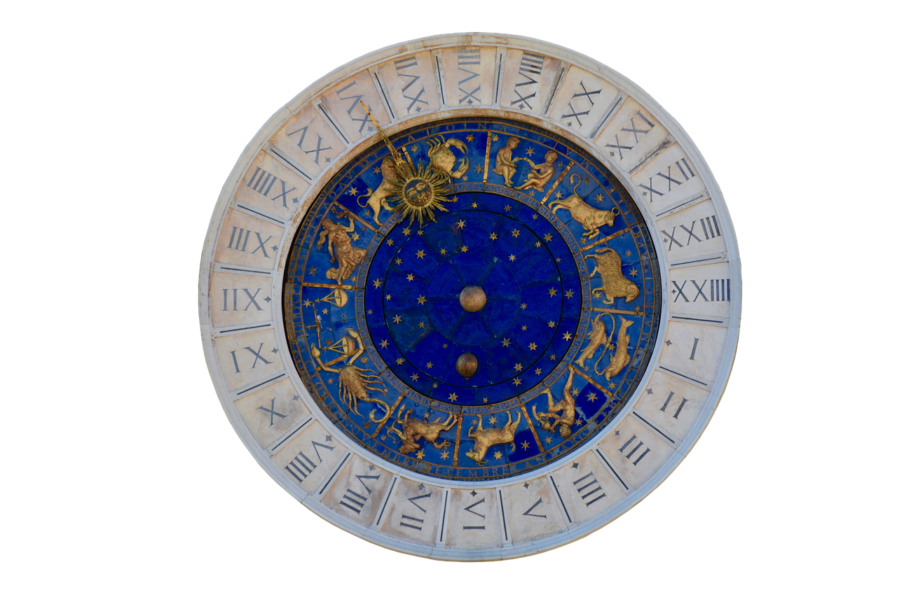 a detailed view of an ornate astrological clock with roman numerals marking the hours and zodiac signs decorating the inner circle. the background is black, highlighting the clock's intricate details and colors.
