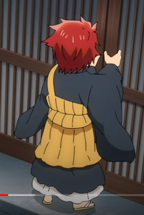 a young anime character wearing a yellow sweater and black kimono stands facing away from the viewer, looking right at a closed wooden door. the boy is redhaired and wears sandals on his feet.  the boy's clothes are made of a very thick material.