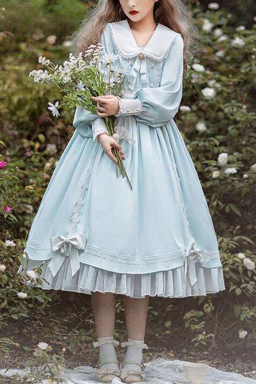 a young girl, dressed in a light blue lolita fashion dress, stands in a garden. she is holding a bouquet of white flowers. the dress is adorned with lace and ribbons. the photo is taken from an eyelevel perspective in natural light.