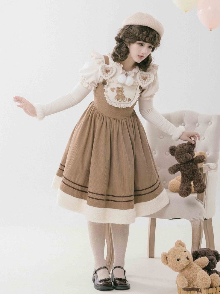 a young woman is wearing a brown lolita fashion dress and a white beret. she is holding a teddy bear and posing in a studio setting. there are balloons in the background. the dress has a cute teddy bear design and the overall aesthetic is sweet and innocent.  she has brown hair styled with a curled fringe and is wearing black mary jane shoes.