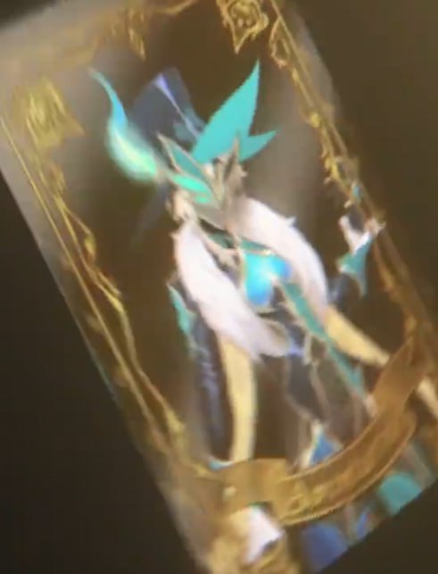 this is a photo of a cosplay of a character from a video game.  the cosplayer is wearing a costume that is similar to the character in the game.  the cosplay is of a magical character, with a blue and white costume and a large, ornate hat.  the background of the photo is a digital rendering of a playing card, which is common in collectible card games.  there is a lot of detail in the photo, with the cosplay, hat, and card background all being finely rendered.  the focus of the photo is the cosplayer's costume, which is very detailed.  the photo is taken from a closeup perspective, showing the details of the costume clearly.  the photo appears to have been taken at a convention or other event, as the cosplayer is dressed in character and the background is a video game character.  the overall tone of the photo is whimsical and magical, with the cosplay being a testament to the creative efforts of the cosplayer.  the photo would likely be enjoyed by fans of the game and video game cosplay.  the photo is wellcomposed, with the cosplayer being the main focal point.  the lighting is good, with the cosplayer being welllit and the background being slightly darker.  the photo has a good balance of color and detail, making it a pleasant viewing experience.