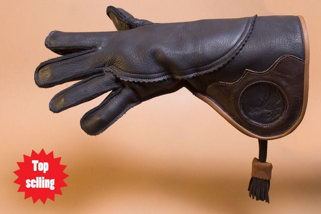 a falconry glove made of dark leather is displayed. the glove is designed to protect the wearer's hand when handling birds of prey. it features a long cuff with decorative stitching and a tassel. a "top selling" tag is visible in the bottom left corner.
