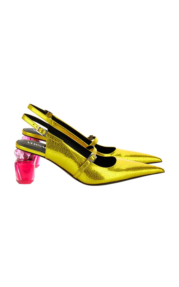 a pair of yellow, gold, leather, slingback, high heels with a pointy toe, a strap, and a buckle.  the heels are clear and pink. the shoes are from versace.