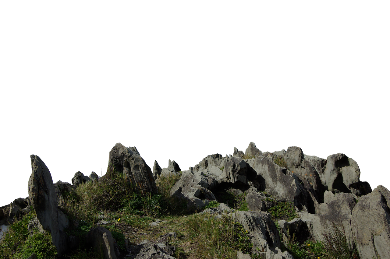 the image shows a landscape with numerous rocky outcrops and grass. the stone formations are gray and appear weathered, suggesting limestone or a similar sedimentary rock. patches of green grass and vegetation grow amongst the stones, adding texture and color. the background is black. the landscape appears to be a hilly or mountainous terrain.