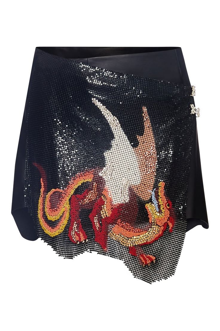 the image shows a black asymmetrical mini skirt adorned with a beaded dragon design. the skirt appears to be made of a dark material, possibly leather or a similar fabric, and features a mesh overlay with sequins. the dragon design is prominently displayed on the front of the skirt, with intricate beading in shades of red, orange, and gold. the skirt has a highwaisted fit and is embellished with sequin detailing.