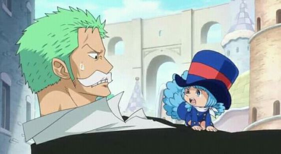 a still image from the anime one piece depicts the swordsman roronoa zoro facing off against the young assassin baby 5.  zoro, significantly larger and with a look of annoyance, contrasts with baby 5's tearful expression. the sunny setting, seemingly a town square, highlights the difference in their demeanors and potential for conflict.