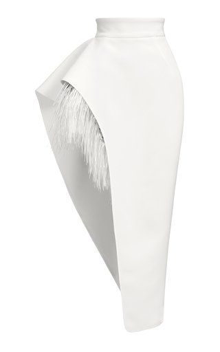 a white skirt with a unique design, featuring a large feather detail on one side.