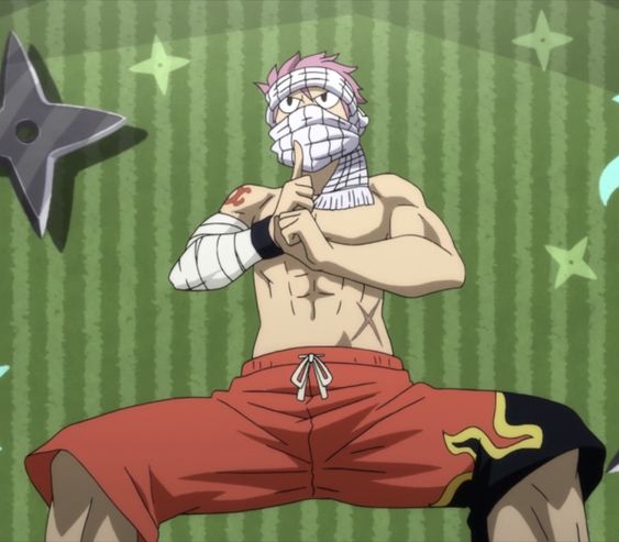 a shirtless and muscular anime character in a fighting stance inside a room. he has bandages wrapped around his head and arms, and is wearing red shorts with yellow flame designs. the walls are green with white stars and black ninja stars.