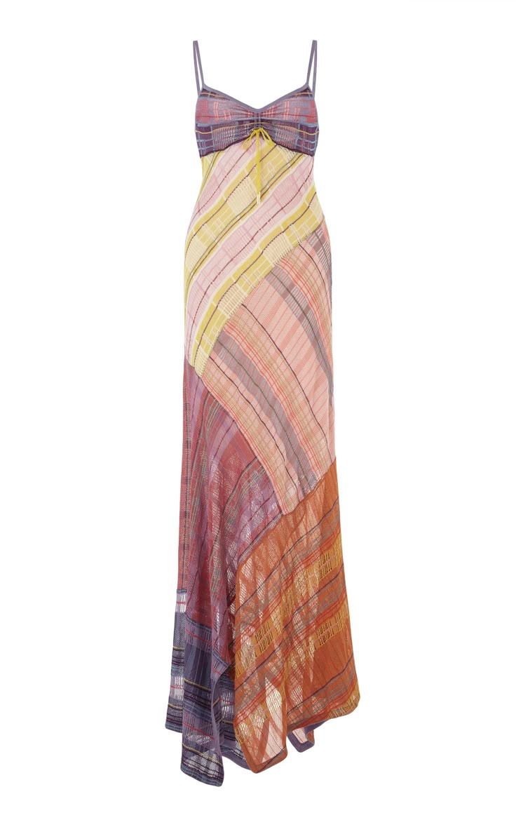 a long, sleeveless dress with a plaid pattern. the dress has spaghetti straps and is made of a lightweight fabric. the plaid pattern is made up of a variety of colors, including yellow, pink, purple, and orange. the dress is casual and would be perfect for a summer day.