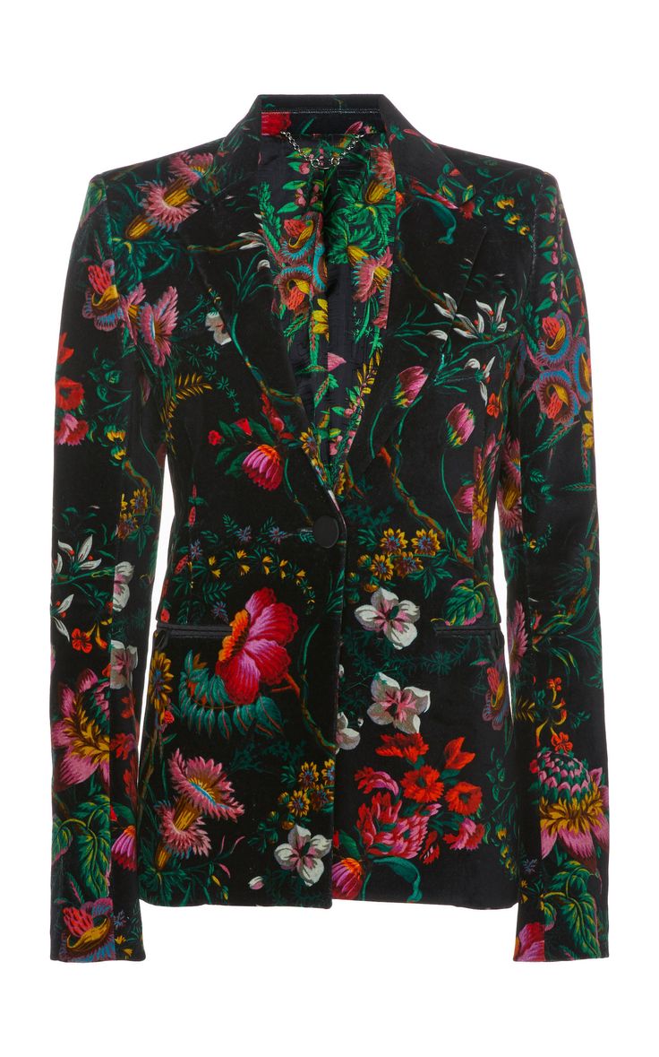 a black velvet blazer with a colorful floral print is displayed against a white background. the jacket features various flowers and foliage in shades of pink, red, green, and yellow. the blazer is singlebreasted with a button closure and a notched lapel.