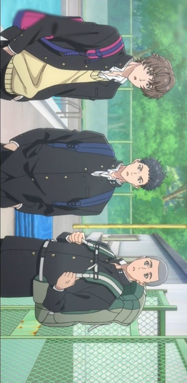 three anime boys wearing school uniforms and carrying backpacks are walking and talking in the schoolyard. the boy in the front is wearing a grey jacket and a black backpack. the boy in the middle is wearing a black jacket with a blue backpack. the boy in the back is wearing a black jacket with a purple backpack. the schoolyard is green and has a grey fence in the background.