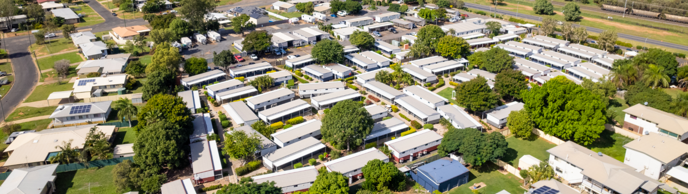 this aerial photo showcases a suburban neighborhood in australia. the houses are wellspaced with lush green lawns and mature trees, creating a tranquil and inviting atmosphere.  the houses are a mix of styles, with some featuring modern designs and others having a more traditional look. there are paved streets and driveways, as well as cars parked in front of the homes.