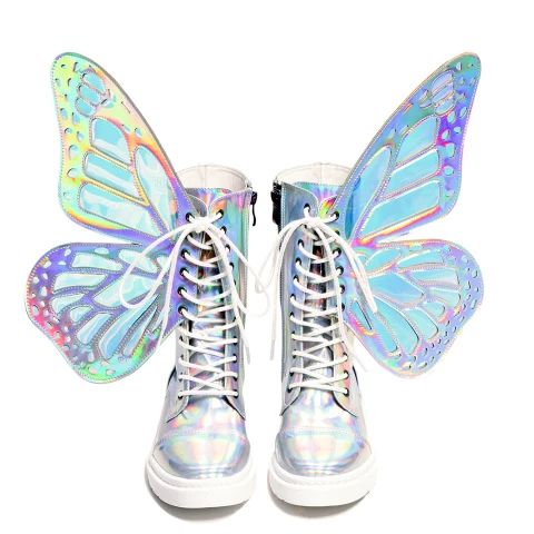the image shows a pair of women's platform boots adorned with large, iridescent butterfly wings. the wings are a holographic material, shifting in color from light blue and pastel shades to silver. the boots themselves are a similar iridescent material and have white laces.  the boots are laceup and appear to be made of a smooth, possibly faux leather, material. they are displayed against a white background, showcasing the full details of the boots and wings. the overall style is whimsical and fantastical.
