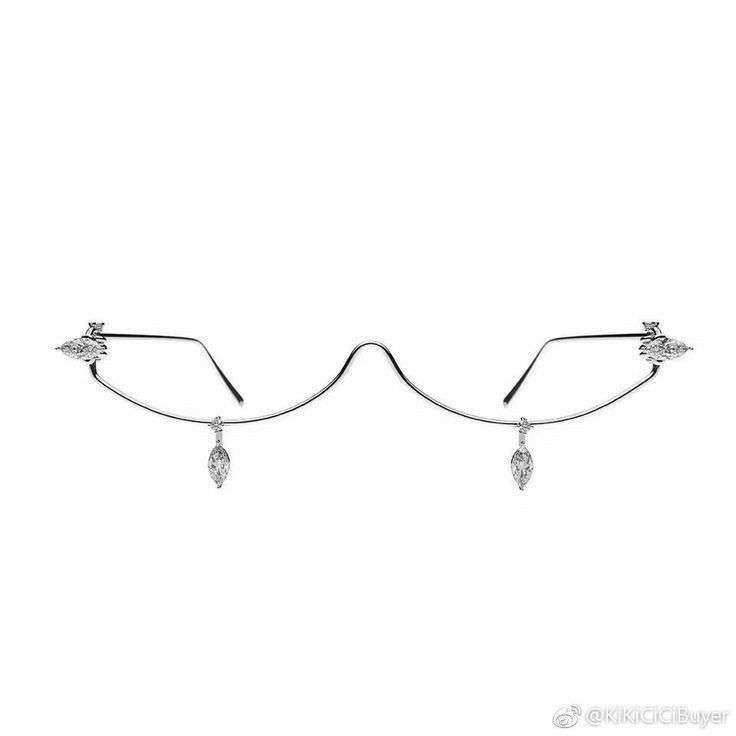a pair of rimless glasses with silver frames and decorative diamondlike jewels on the sides and hanging from the bottom of the lenses. the glasses have a unique design with a wavy bridge.