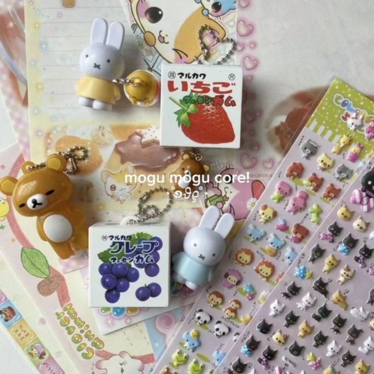 the image contains an assortment of cute and kawaii items, including keychains of miffy and rilakkuma, stickers featuring cartoon animals, and japanese candy boxes with flavors like strawberry and grape. the aesthetic appears to be aligned with mogu mogu core.