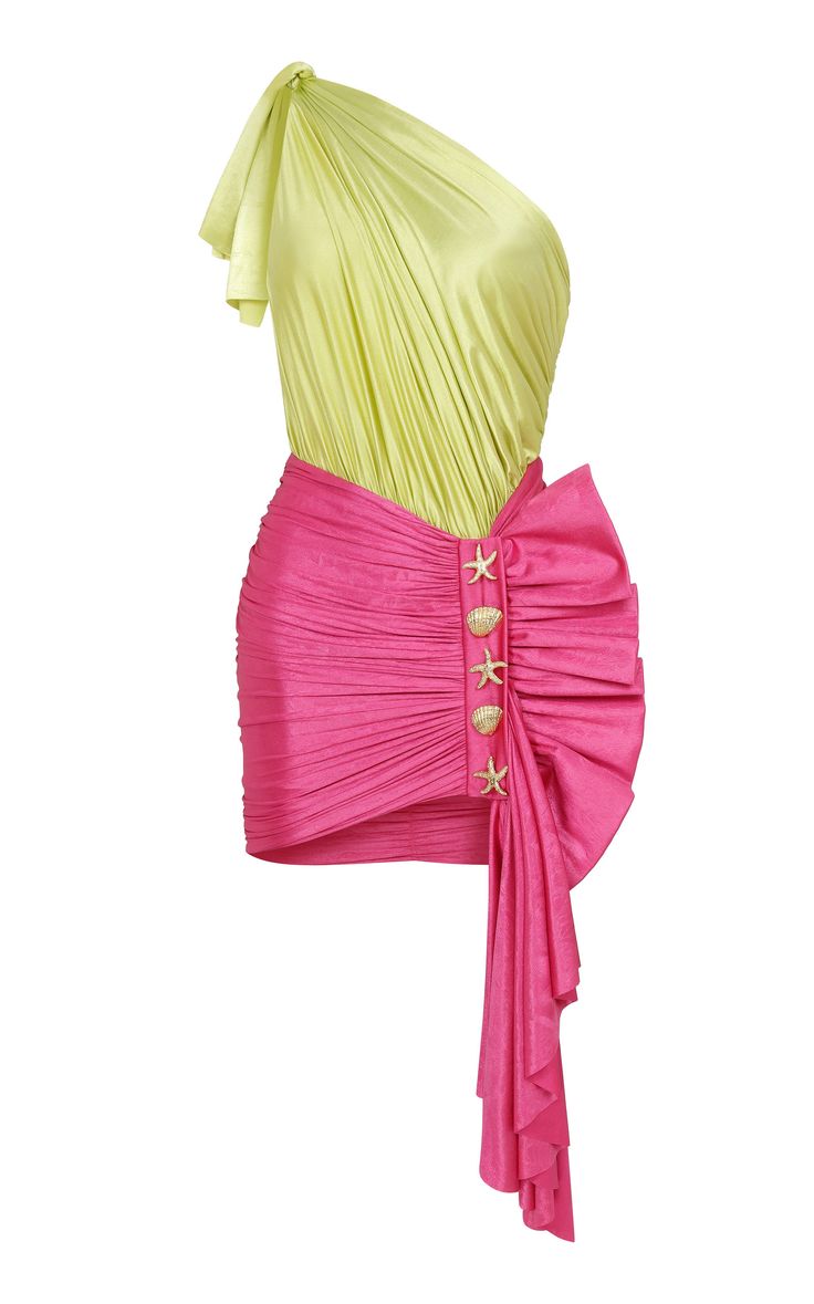 a brightly colored oneshoulder mini dress with a green, draped bodice and a pink, ruched skirt with a large draped panel along the side. the skirt is adorned with a row of decorative starfish and seashell buttons.