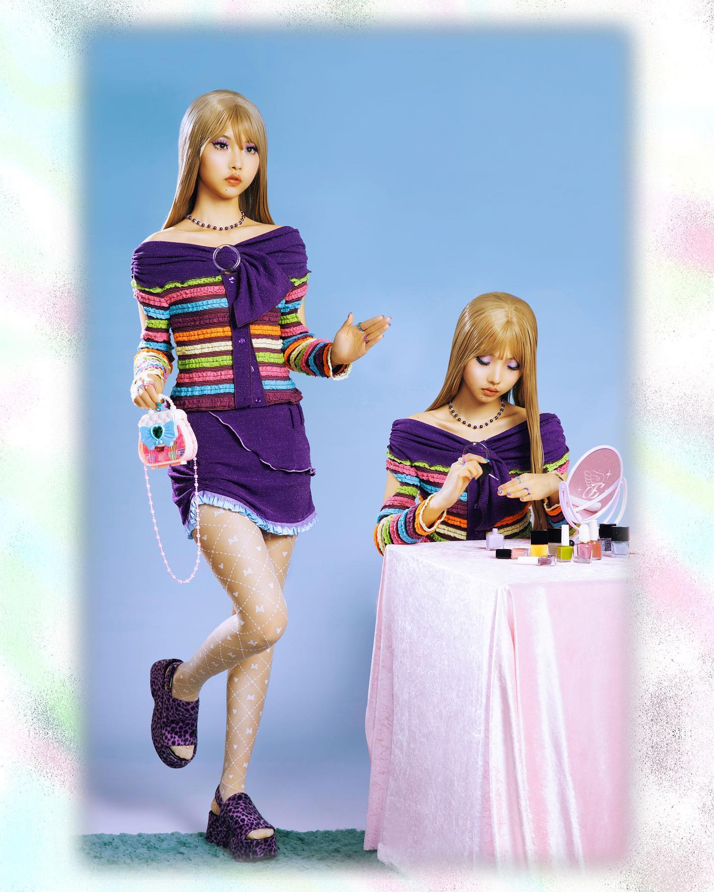 the image shows two identicallooking girls dressed in matching outfits.  they are wearing purple offshoulder striped sweaters, purple mini skirts, white patterned tights, and purple platform shoes. one girl is holding a small handbag and posing while the other girl sits at a pink table applying nail polish. the backdrop is a pastel blue wall. the overall style is reminiscent of y2k or 90s fashion.  the setting is a studio, suggesting a professional photoshoot possibly for a kpop group or a fashion campaign.