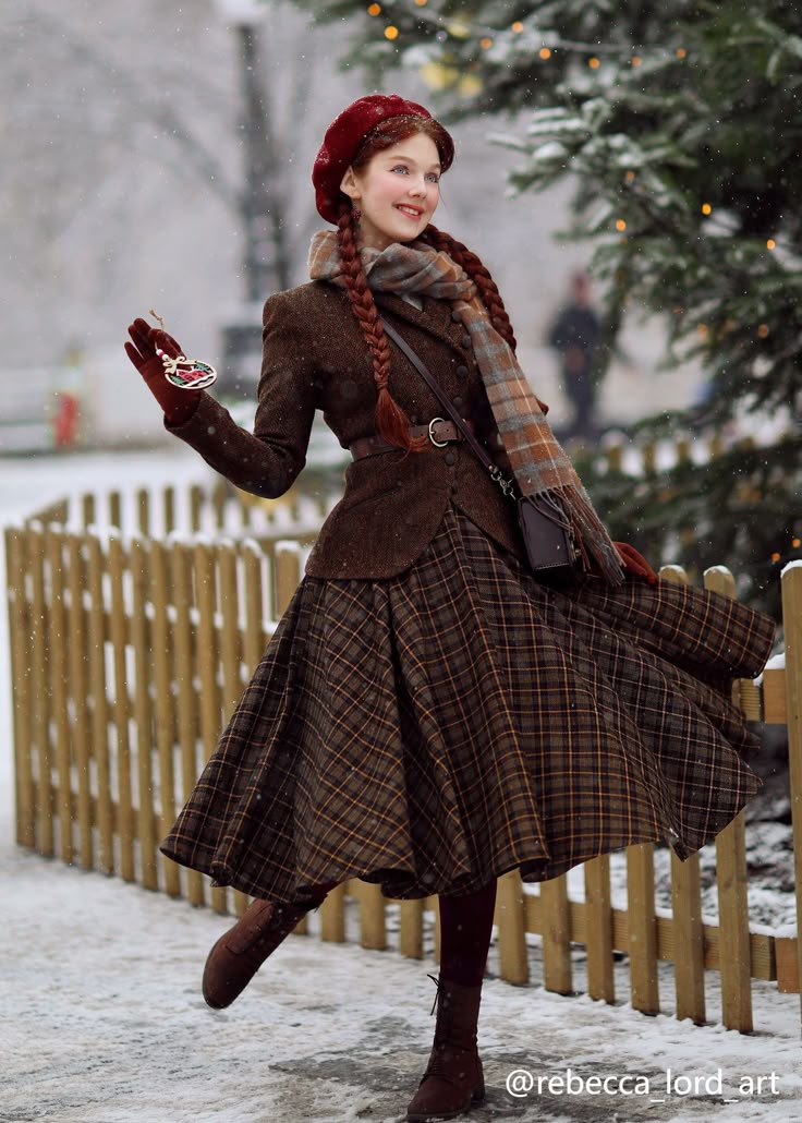 a woman dressed in winter attire is outdoors in a snowy scene. she wears a brown jacket, a plaid skirt, a scarf, a red beret, and brown boots. her hair is styled in braids. she is holding a christmas ornament. a decorated christmas tree and a wooden fence are visible in the background.